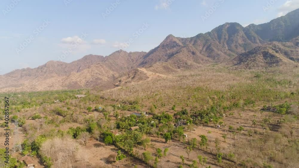 aerial view agricultural land and mountains in countryside. mountain range with high cliffs mountain slopes covered with vegetation bali, indonesia aerial view agricultural land and mountains in countryside. mountain range with high cliffs mountain slopes covered with vegetation bali, indonesia