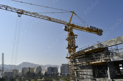 Tower crane in a new civil construction site Building in Oman. Oman city. Muscat, Oman 