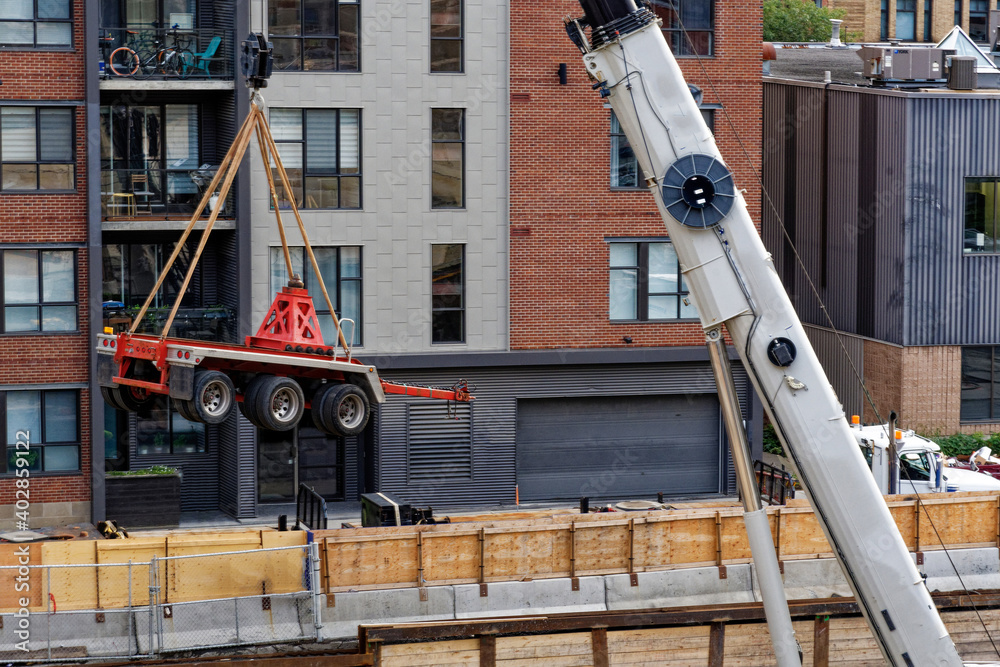 Close up view of a crane lifting construction site equipment Close up view of a crane lifting construction site equipment