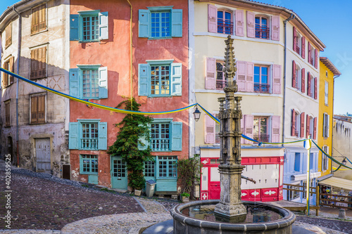 Medieval street of the old town of le Puy en Velay (Auvergne, France) with colorful facades
