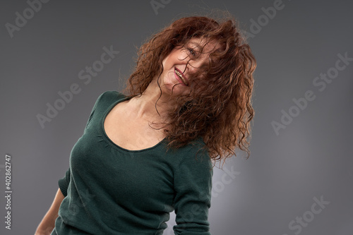 Senior woman on gray background photo