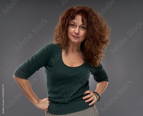 Senior woman on gray background photo