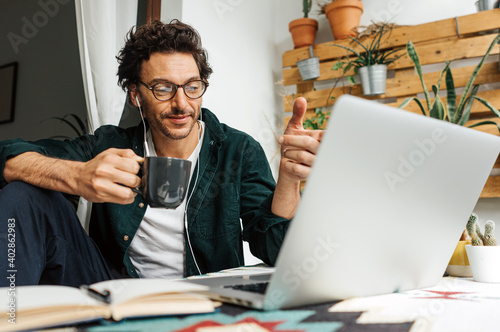 Man with laptop working remotely from home photo