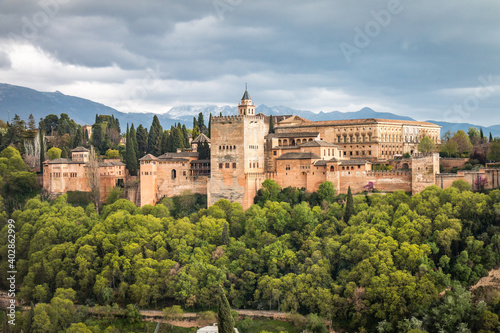 alhambra palace with snow capped mountains in background