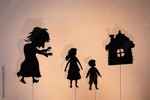Shadow puppets of boy, girl, witch and gingerbread house