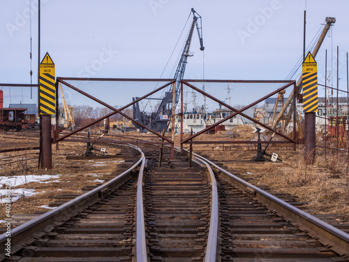 Rail road tracks under the gantry cranes on the berth of sea merchant port