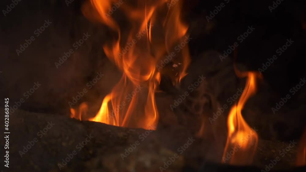 Slow Motion Orange Fire Flames Dance on Logs in Fireplace, Closeup Slow Motion Orange Fire Flames Dance on Logs in Fireplace, Closeup