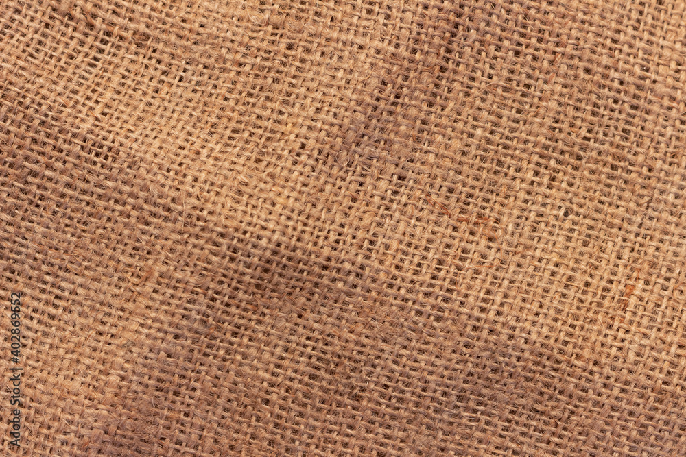 The texture of an uneven crumpled, roughly woven burlap. The texture of an uneven crumpled, roughly woven burlap.
