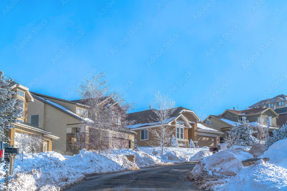 Scenic town landscape on a snowy setting against blue sky on a sunny winter day