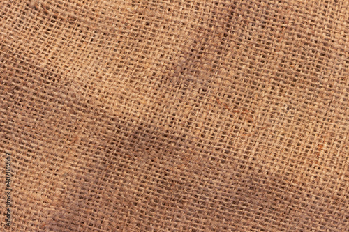 The texture of an uneven crumpled  roughly woven burlap.