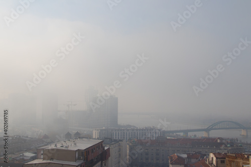 City pollution in foggy Belgrade, capitol of Serbia, industrial chimneys with polluted smoke and air