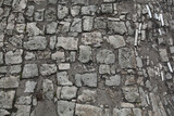 The road is paved with stones. Background texture of old stones