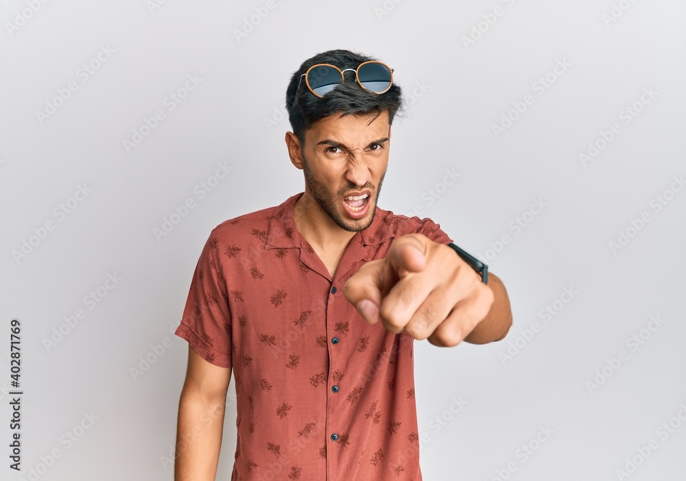 Fototapeta premium Young handsome man wearing casual summer clothes pointing displeased and frustrated to the camera, angry and furious with you