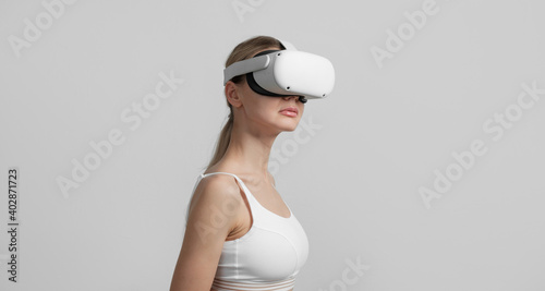 young woman in vr helmet on her head on a light background