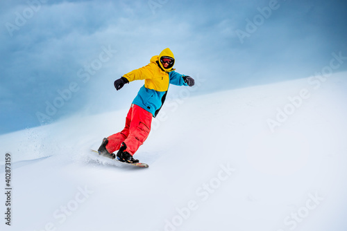 Snowboarder Riding Snowboard in the Mountains. Snowboarding and Winter Sports
