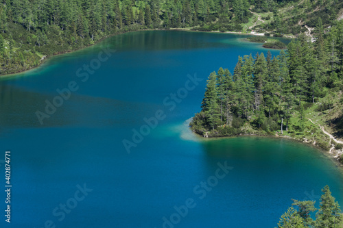 gorgeous blue mountain lake with forest while hiking