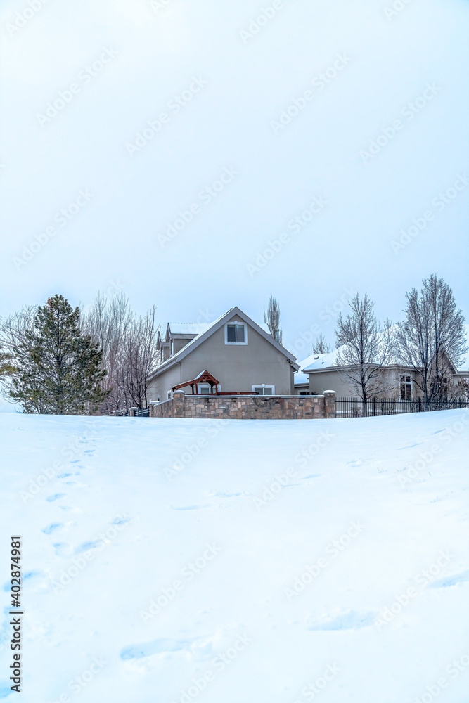 Exterior of gated houses in the midst of snow covered terrain by the Utah Lake