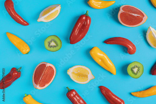 Lemon, kiwi,grapefruit,red and yellow chili pepper pattern on blue background.