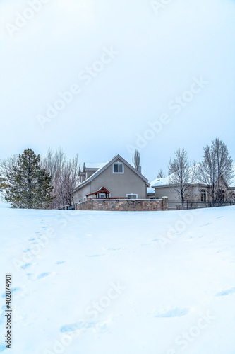 Exterior of gated houses in the midst of snow covered terrain by the Utah Lake © Jason