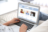 Young woman visiting online dating site via laptop indoors, closeup
