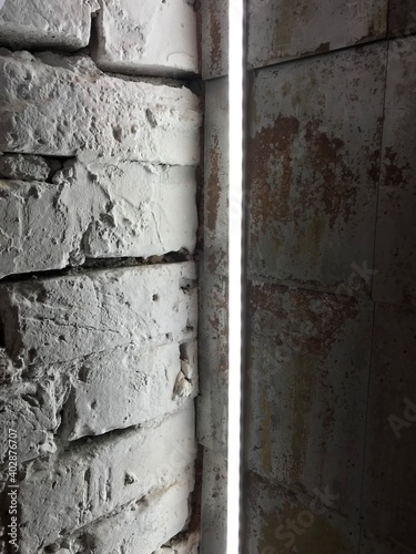  Gray brick wall. Led lighting. Corner composition