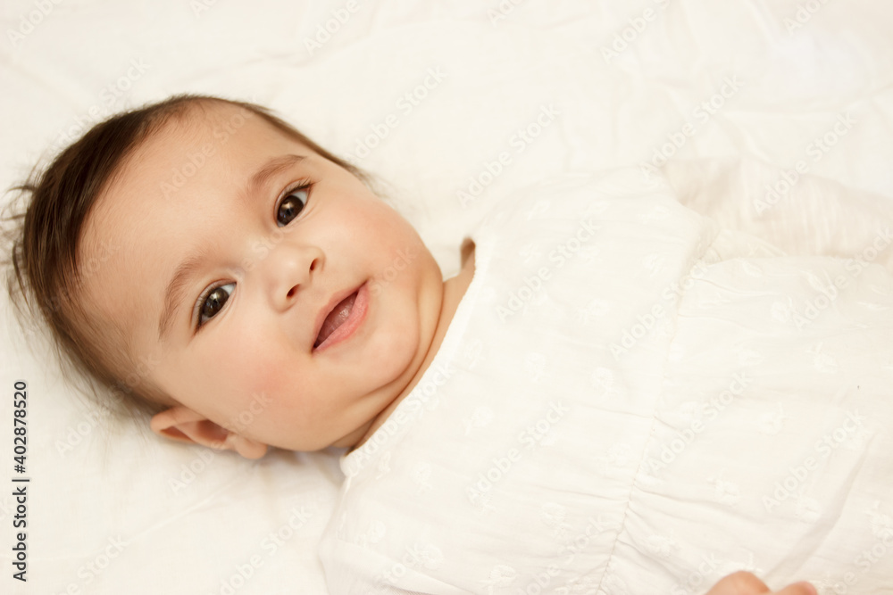 Little cute baby girl on the blanket, indoors Little cute baby girl on the blanket, indoors