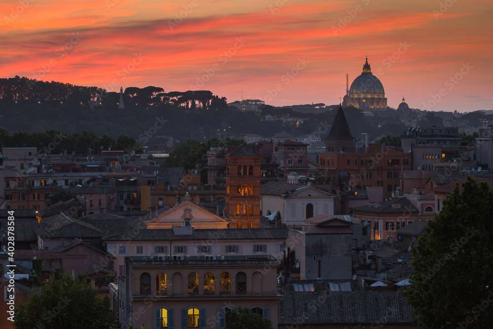 Panoramic colorful view of Rome at sunset City skyline with Saint Peter Basilica in the background in a summer evening, Rome, Italy
