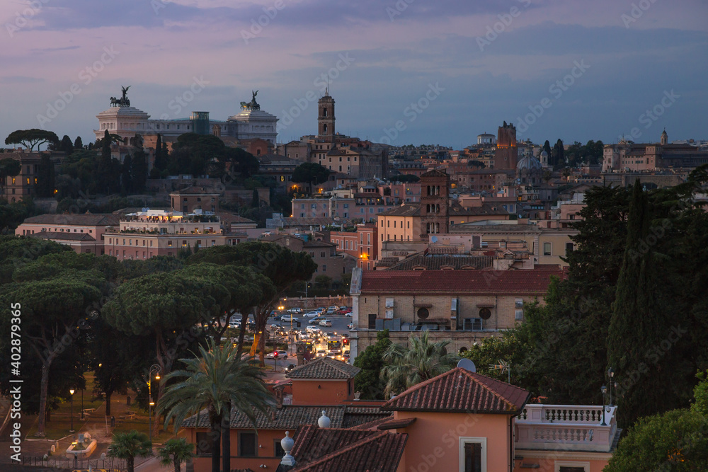 Rooftop view of the city skyline of Rome at sunset. Skyline showing the Victor Emmanuel II Monument in the distance, Rome, Italy
