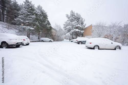 cars in the snow in the parking lot. Concept, snowy winter, utilities, snow removal