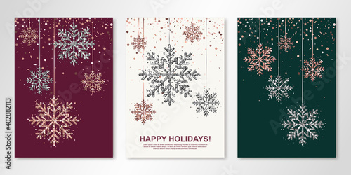 Happy Holidays banners set with rose gold and silver hanging snowflakes. Vector winter design templates for invitations, greeting cards. All isolated and layered