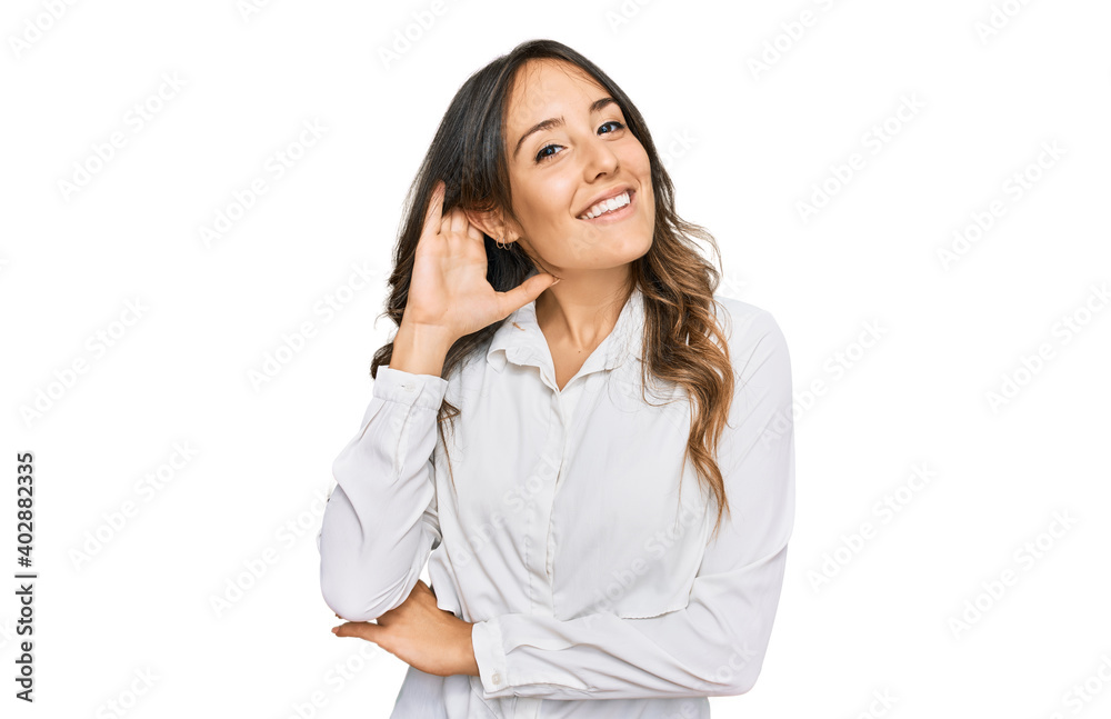 Young brunette woman wearing casual clothes smiling with hand over ear listening an hearing to rumor or gossip. deafness concept. Young brunette woman wearing casual clothes smiling with hand over ear listening an hearing to rumor or gossip. deafness concept.