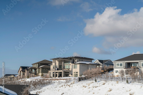 Luxury houses on a scenic mountain neighborhood blanketed with snow in winter