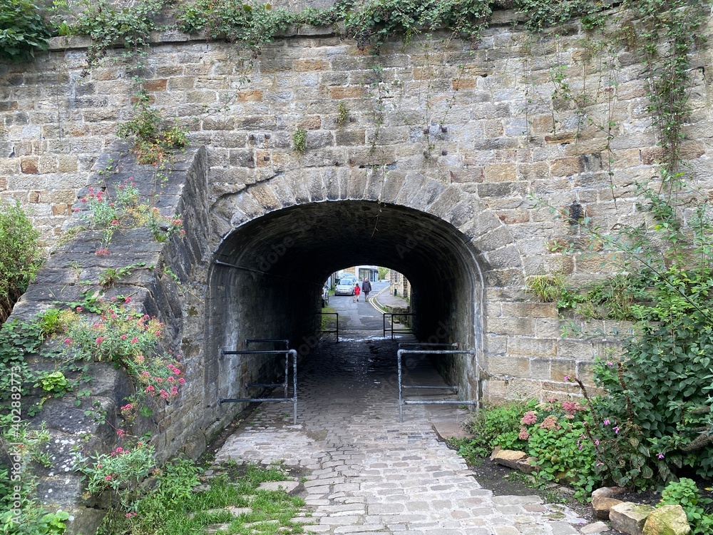 Large stone aqueduct, that carries the, Leeds and Liverpool canal, over a stone cobbled path in, Silsden, Keighley, UK