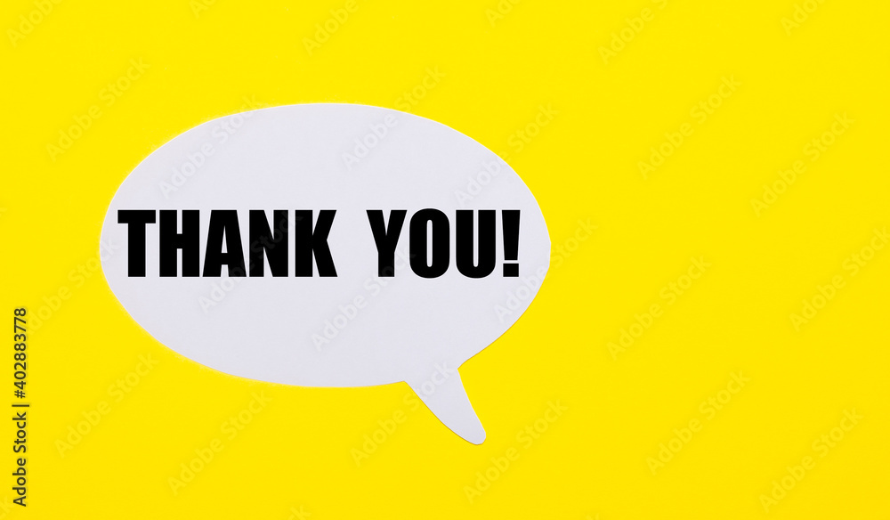 On a bright yellow background, white paper with the words THANK YOU On a bright yellow background, white paper with the words THANK YOU