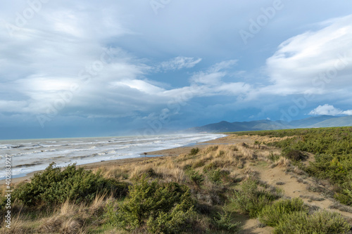 Italy Tuscany Maremma Grosseto, Marina di Grosseto beach, view of the stormy sea, Castiglione della Pescaia in the background