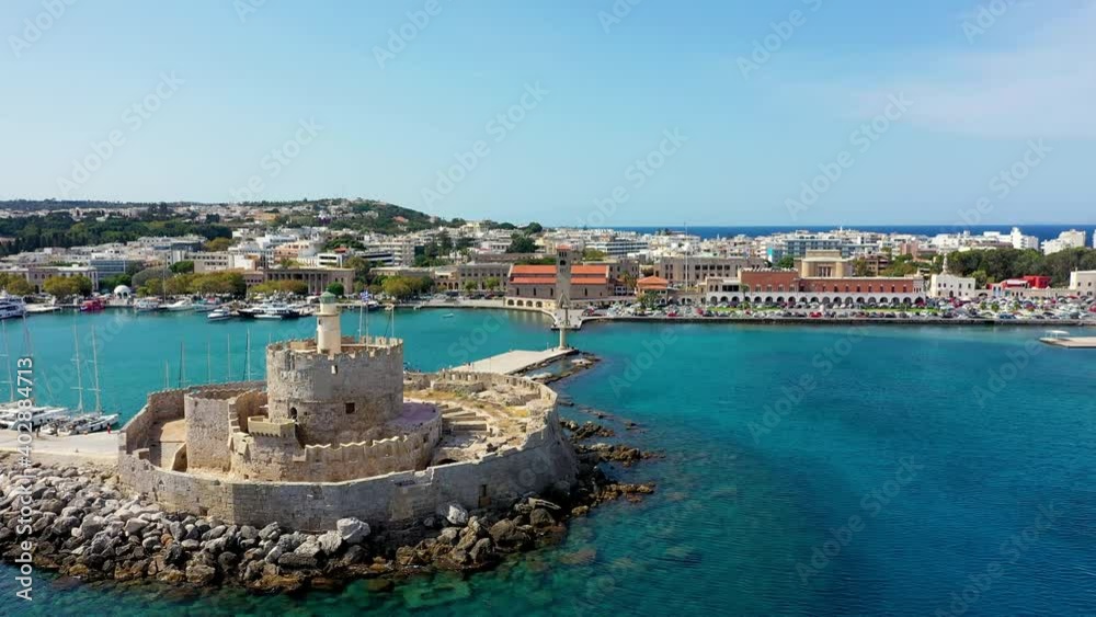 Mandraki port with deers statue, where The Colossus was standing and fort of St. Nicholas. Rhodes, Greece. Hirschkuh statue in the place of the Colossus of Rhodes, Rhodes, Greece