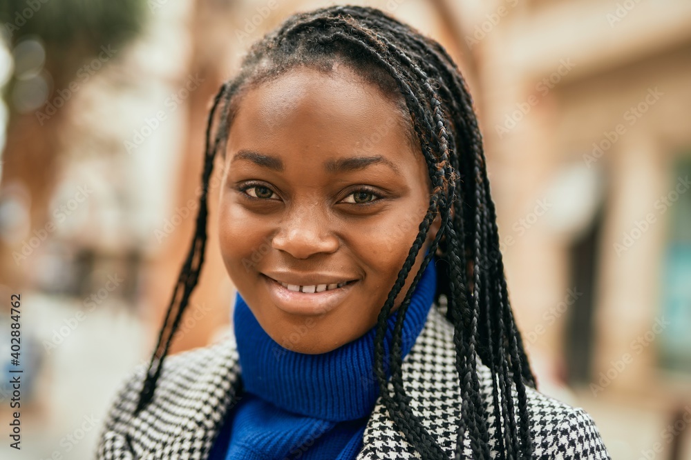 Young african american businesswoman smiling happy standing at the city. Young african american businesswoman smiling happy standing at the city.