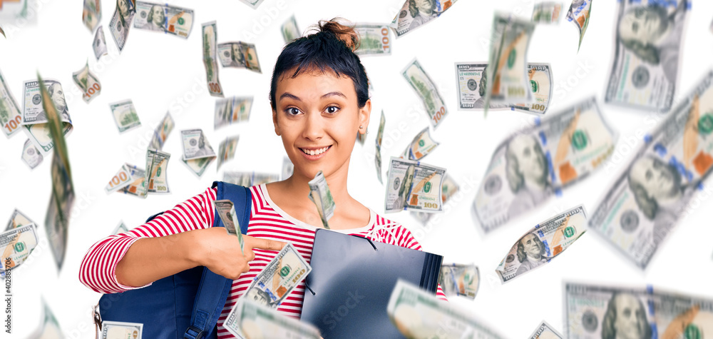 Obraz premium Young woman wearing student backpack holding binder pointing finger to one self smiling happy and proud