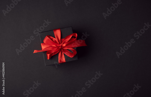 Top view of black gift boxes with red ribbon on black background with copy space for text. The Concept Of Valentine's Day.
