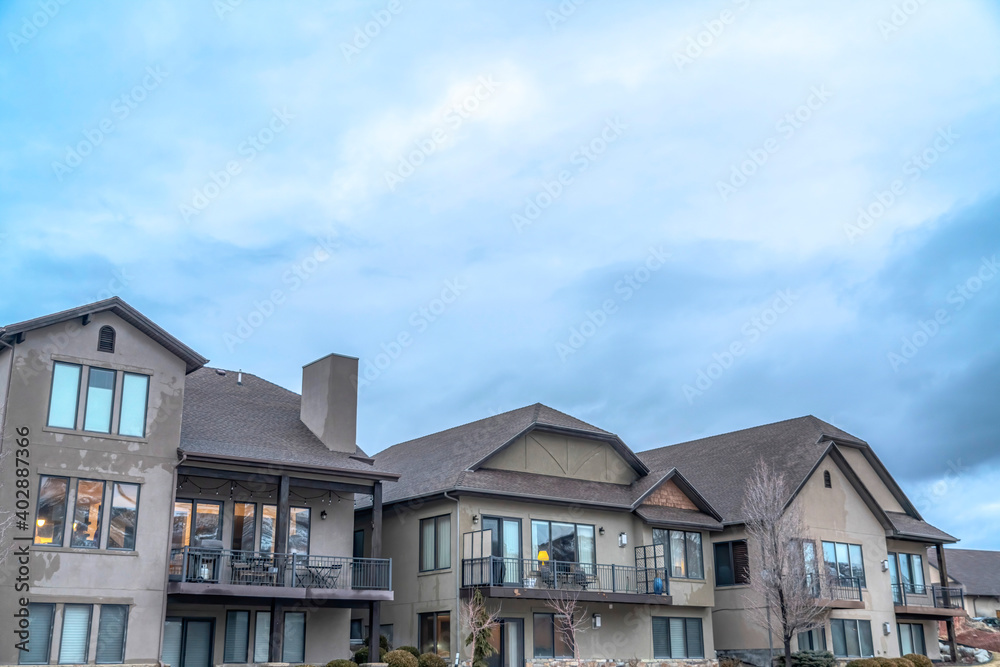 Exterior of houses against dense cloudy sky on a scenic suburban neighborhood Exterior of houses against dense cloudy sky on a scenic suburban neighborhood