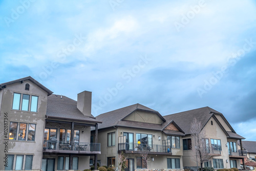Exterior of houses against dense cloudy sky on a scenic suburban neighborhood