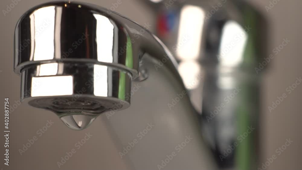 Closeup Of Water Dripping From A Dirty Metal Tap With Limescale Closeup Of Water Dripping From A Dirty Metal Tap With Limescale