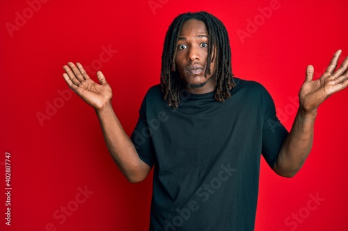 African american man with braids wearing casual clothes clueless and confused with open arms, no idea and doubtful face. © Krakenimages.com