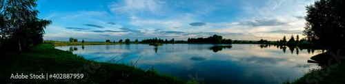 Panoramic view of a calm lake on a sunny summer day