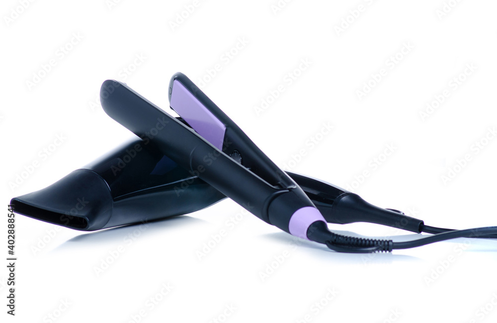 Hair straightener iron and hair dryer on white background isolation Hair straightener iron and hair dryer on white background isolation