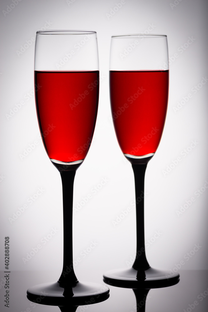 Two glasses of red wine on a white background