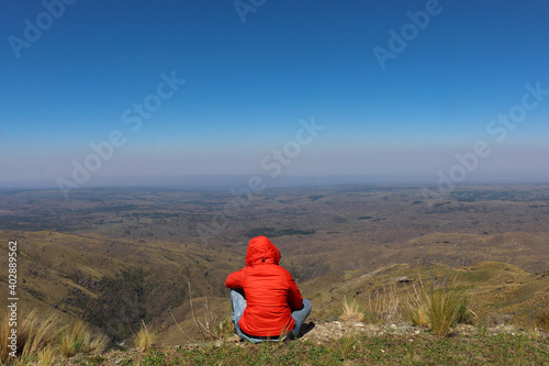 woman sitting on a mountain top peacefully - Cerro champaqui, cordoba, argentina photo