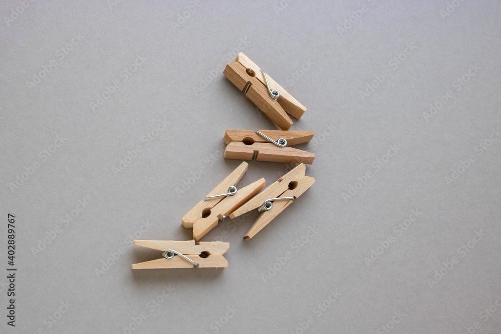 Set of small wooden clothespins for decoration on a gray background Set of small wooden clothespins for decoration on a gray background