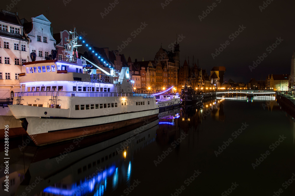 Ships on the Motlawa river, old town of Gdansk by night, Poland
