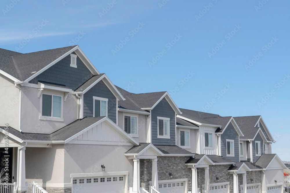 Facade of contemporary houses on a scenic suburban neighborhood landscape Facade of contemporary houses on a scenic suburban neighborhood landscape